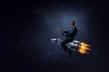 Fototapeta na wymiar Businessman on a rocket . Mixed media