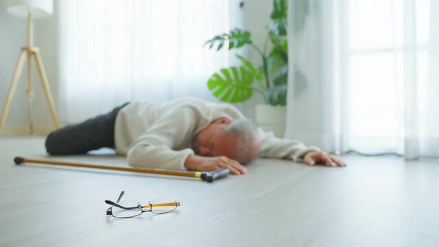 Asian senior male falling on the ground while walk with walker at home
