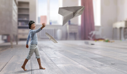 Happy kid playing with paper airplane . Mixed media