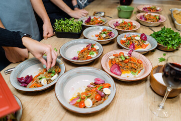 Beef tongue with champignon mushrooms, salad with onions and capers. Dishes in a restaurant on the table.