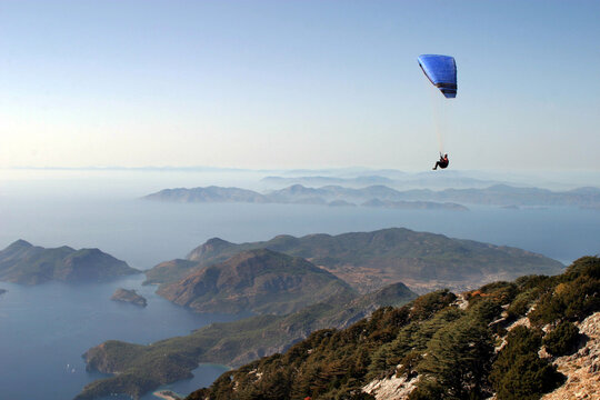 Paraglider fly from Mount Babadag in Fethiye, Turkey. Mount Babadag near Fethiye and a famous paragliding area in Turkey.