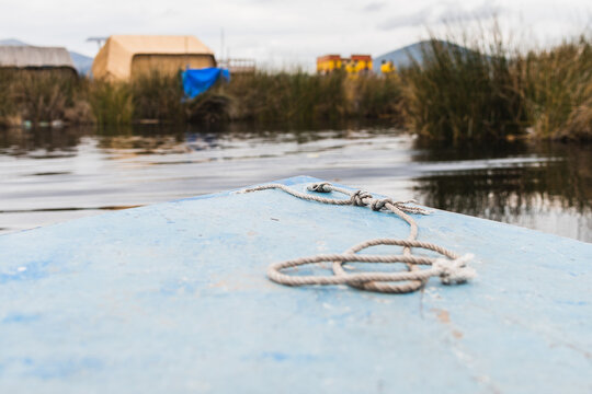 Wide Angle First Person View Of A Boat Sailing In A River With Some Vegetation Beside.