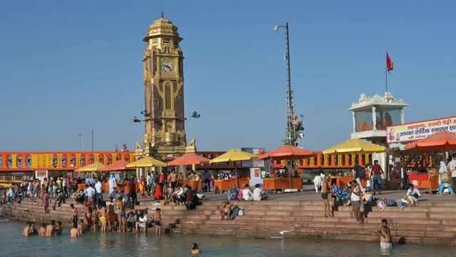 Haridwar, Uttarakhand, India - 10th April 2021 : Hindu devotees bathing in Har Ki Pauri Ghat, Holy river Ganges, on the occassion of Kumbh Mela. Ritual is called shahi snan, shaahi snan or Kumbh snan.
