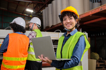 Portrait of safety uniform female engineer worker and hard hat with laptop looks at camera, happy smile and cheerful, industry jobs success, achievement, professional technician manufacture factory.