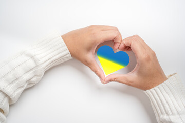 Save Ukraine no more war in the concept of woman hand and the flag in heart shape. The patriotism...