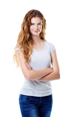 Fototapeta premium Keeping things casual. Portrait of an attractive young woman standing with her arms crossed against a white background.