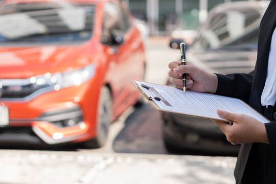 car rental advertising ideas Asian female worker holding rental documents in front There was a car in the back, a professional woman stood in front of the car holding a clipboard in her hand.