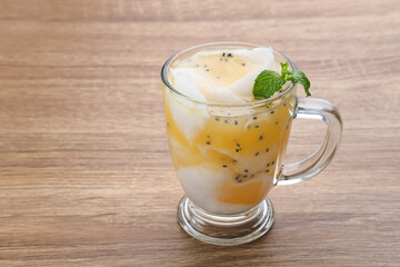 Es Kelapa Jeruk, a typical Indonesian drink made from fresh oranges squeezed with grated young coconut.
