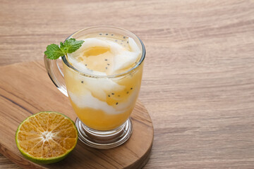 Es Kelapa Jeruk, a typical Indonesian drink made from fresh oranges squeezed with grated young coconut.
