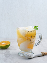 Es Kelapa Jeruk, a typical Indonesian drink made from fresh oranges squeezed with grated young coconut.
