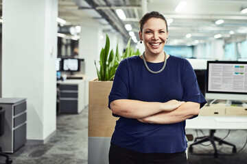 Confidence is a key feature for achieving success. Portrait of a young designer standing in an office.