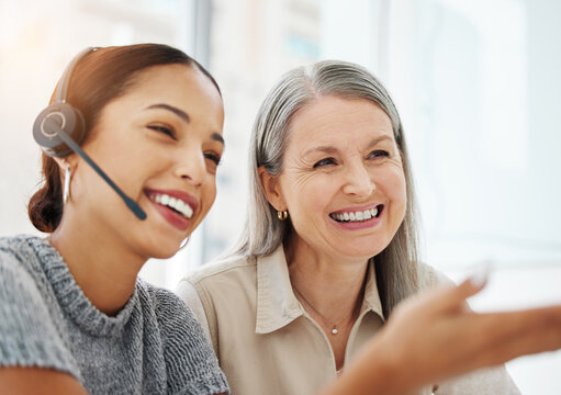 I Dont Know How To Respond To This. Shot Of An Attractive Young Call Centre Agent Sitting In The Office And Getting Help From Her Manager.