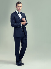 Confident and classic. A full length studio shot of a handsome young man in a stylish vintage suit.