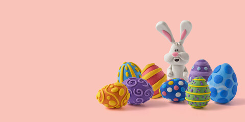 Easter greeting card with cute bunny and easter eggs. Handmade from plasticine on a pink background with copy space
