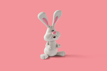 Easter bunny design handmade with plasticine on a pink background