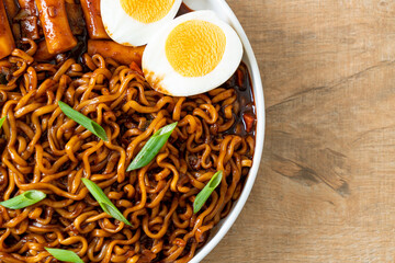 Jjajang Rabokki - Korean instant noodles or Ramyeon with Korean rice cake or Tteokbokki and egg in black bean sauce