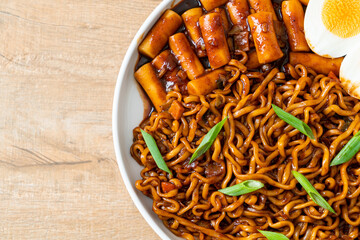 Jjajang Rabokki - Korean instant noodles or Ramyeon with Korean rice cake or Tteokbokki and egg in black bean sauce