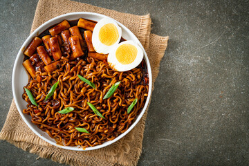 Jjajang Rabokki - Korean instant noodles or Ramyeon with Korean rice cake or Tteokbokki and egg in black bean sauce