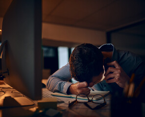 When bad news comes calling. Shot of a young businessman looking stressed out while talking on a cellphone in an office.