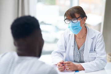 Connecting with patients is the key. Shot of a female doctor speaking to a patient in her office.