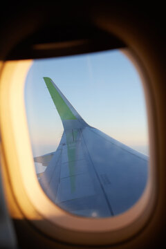 The view from the window of the aircraft on the wing in flight. Vertical photo.