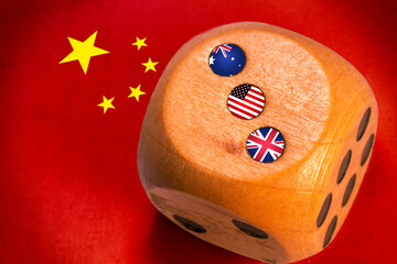 australia, uk and usa AUKUS alliance countries flags paint over on wooden dice. chinese flag paint...