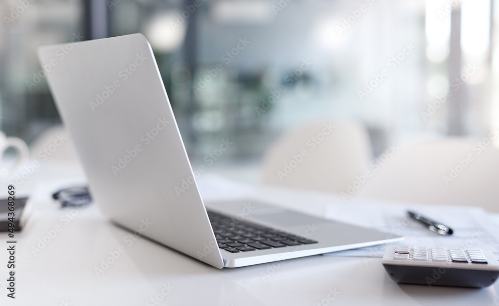 Poster technology will help you figure it all out. closeup shot of a laptop and calculator on a desk in an 