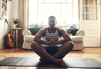 A little focus can drive so much positivity into your life. Shot of a sporty young man meditating...
