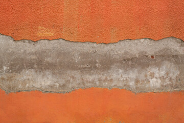 Orange painted damaged concrete wall