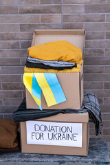 Boxes with humanitarian aid for Ukrainian refugees on the street. Ukrainian symbols, boxes with...