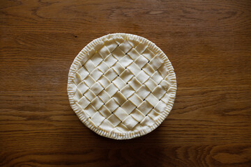 Top view of homemade apple pie on a wooden table. Making apple pie. Space for copy.