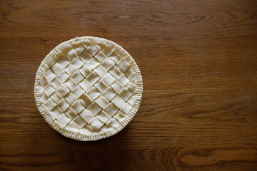 Top view of homemade apple pie on a wooden table. Making apple pie. Space for copy.