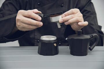 Fototapeta na wymiar Asian barista is making hot coffee using moka pot