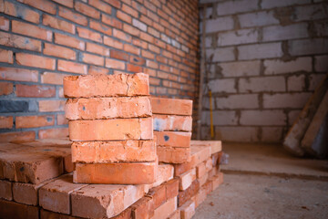 Obraz premium Red ceramic brick closeup stacked. building materials