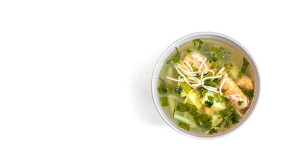 salmon and potato soup with greens on a white background, top view to the right of the frame