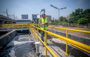 Worker under checking the waste water treatment pond industry large to control water support industry	 - obrazy, fototapety, plakaty