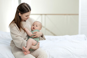 Fototapeta na wymiar Mom and baby. Beautiful woman with a baby at home. High quality photo