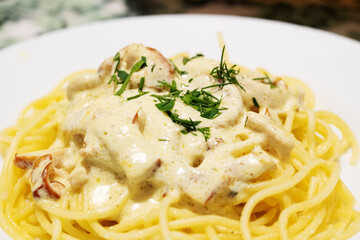 Pasta carbonara with cheese on a white plate