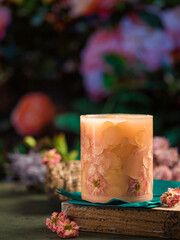 Handmade candles of a unique design, with different flowers, dry leaves on a light background. Candles made from organic wax, paraffin wax. Relaxation atmosphere. Luxurious lifestyle.