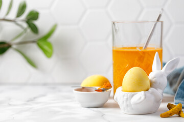 Natural coloring Easter eggs with turmeric powder in yellow color. Copy space.