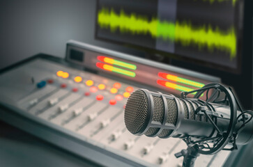 Professional microphone, sound mixer and wave form on the screen