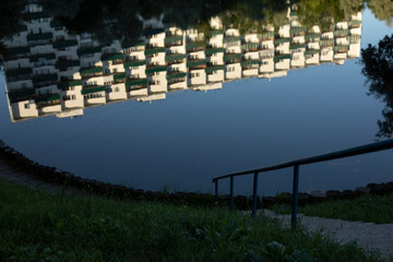 Fototapeta na wymiar Pond in city. Lake in park. Surface of water.