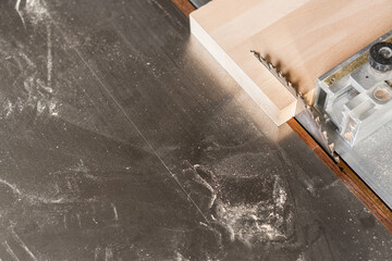 Wooden plank near metal sliding table saw