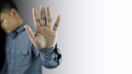 Asian men are raising their hands to ban or stop in body language that indicates deny, drugs,...