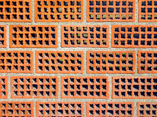 perforated brick wall, with concrete joints forming a texture
