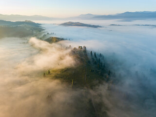 Morning mist in Ukrainian Carpathian mountains. Aerial drone view.