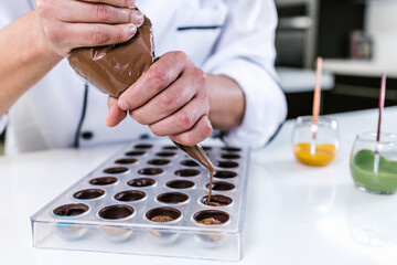 hispanic man pastry chef wearing uniform in process of preparing delicious mexican sweets...