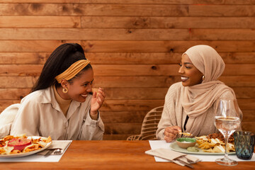 Best friends laughing cheerfully in a restaurant