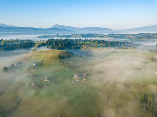 Morning mist in Ukrainian Carpathian mountains. Aerial drone view.