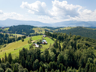 Green mountains of Ukrainian Carpathians in summer. Sunny day. Aerial drone view.